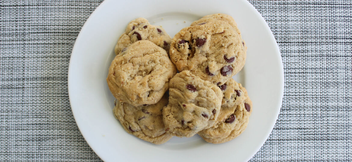 Plate of warm chocolate chip cookies; overeating cookies